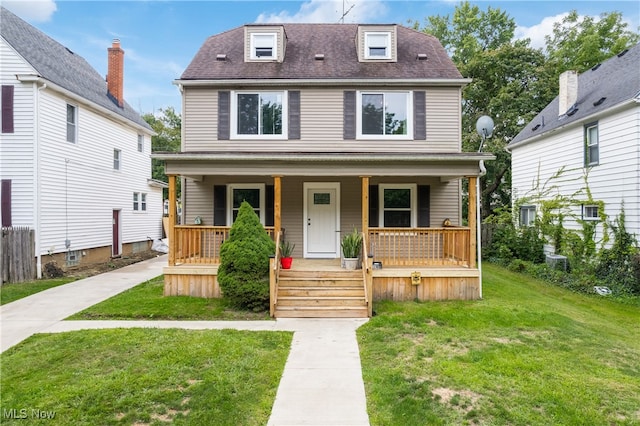 view of front of house featuring a front lawn and covered porch