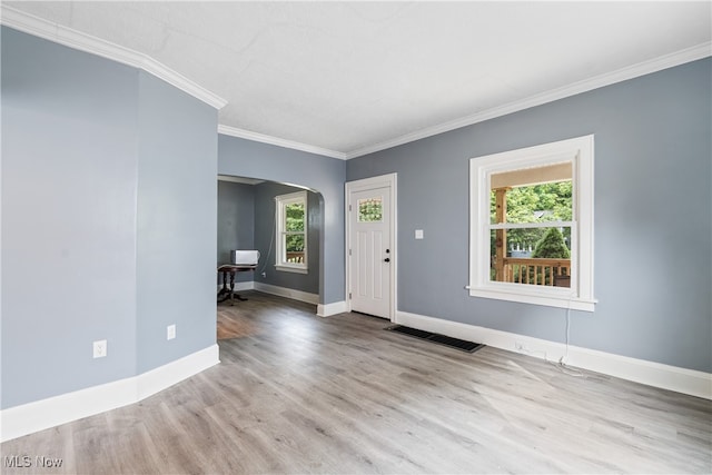 entryway with crown molding, plenty of natural light, and light hardwood / wood-style flooring