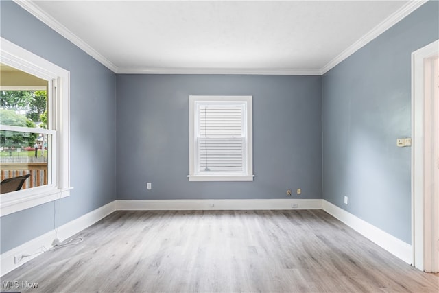 unfurnished room with light hardwood / wood-style flooring and crown molding