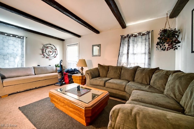 carpeted living room with beamed ceiling