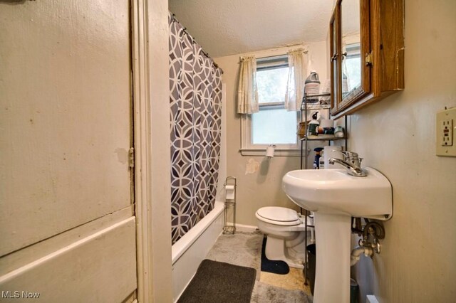 bathroom featuring toilet, a textured ceiling, tile patterned flooring, shower / tub combo, and lofted ceiling