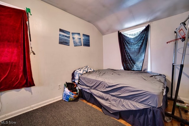 bedroom with carpet and vaulted ceiling