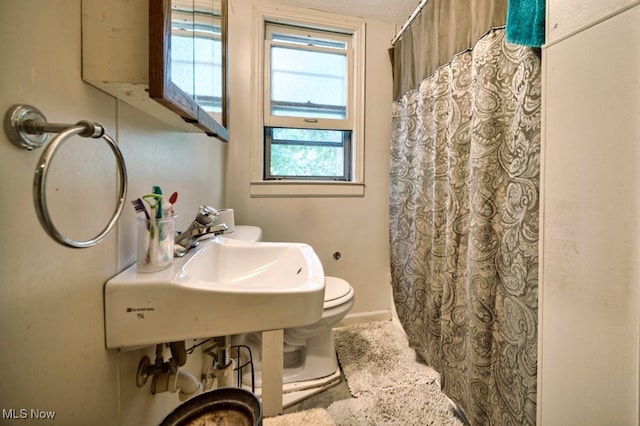 bathroom featuring a textured ceiling and toilet