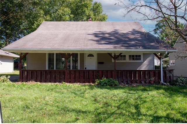 view of front of home with covered porch and a front yard