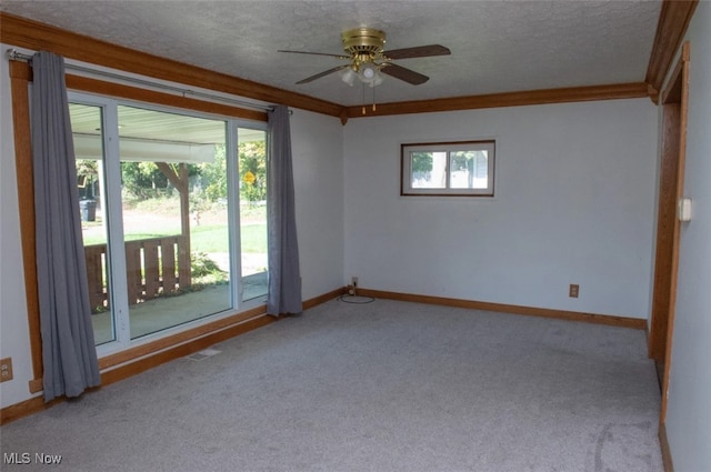 spare room featuring ceiling fan, light colored carpet, a textured ceiling, and crown molding