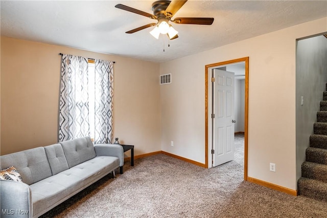 living area featuring stairway, carpet, visible vents, and baseboards