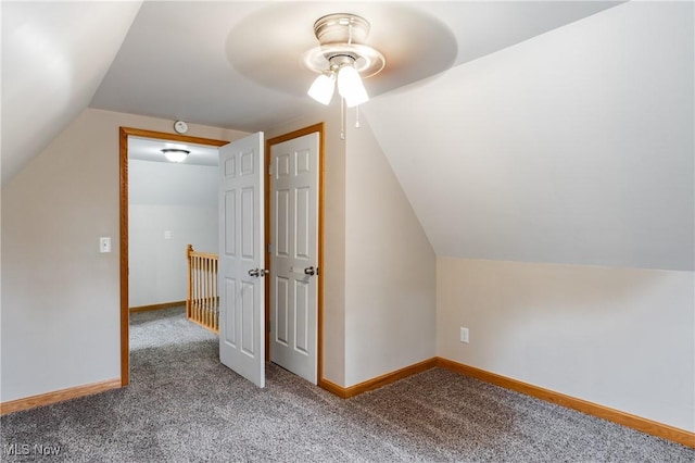 additional living space with vaulted ceiling, ceiling fan, carpet flooring, and baseboards