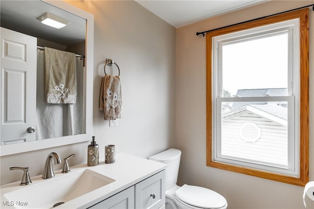 full bath featuring vanity and toilet