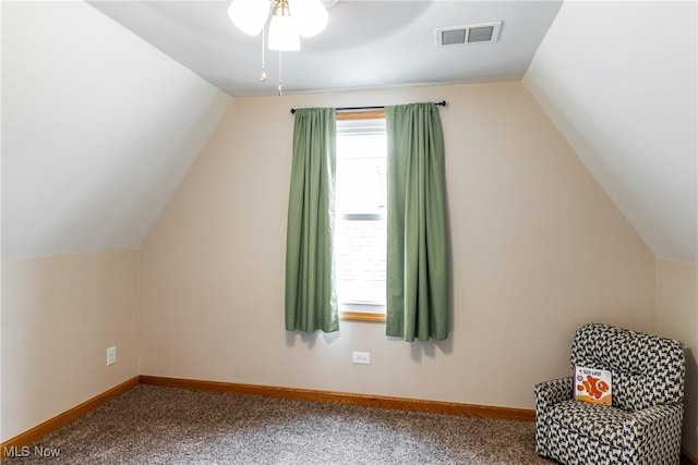 additional living space with lofted ceiling, baseboards, visible vents, and carpet flooring