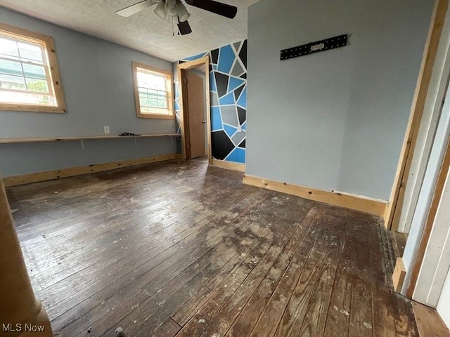 spare room featuring a textured ceiling, ceiling fan, and hardwood / wood-style flooring