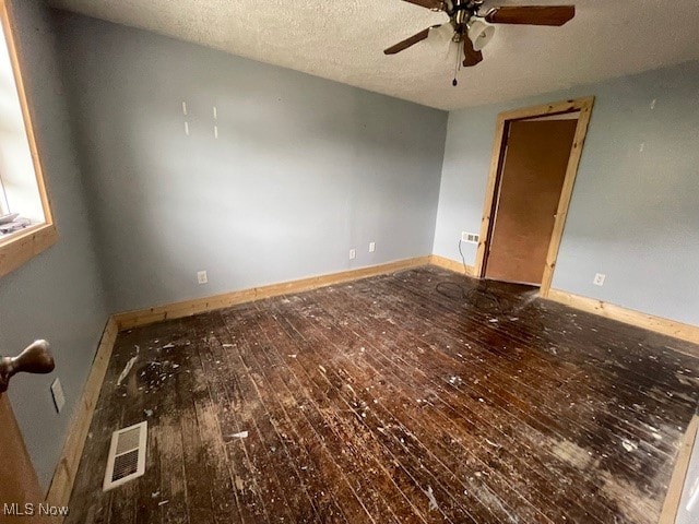 unfurnished room featuring ceiling fan, a textured ceiling, and wood-type flooring