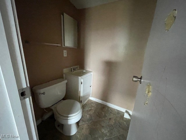 bathroom featuring tile patterned floors, toilet, and vanity