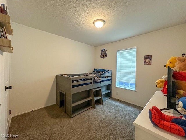 bedroom featuring a textured ceiling, dark colored carpet, and baseboards