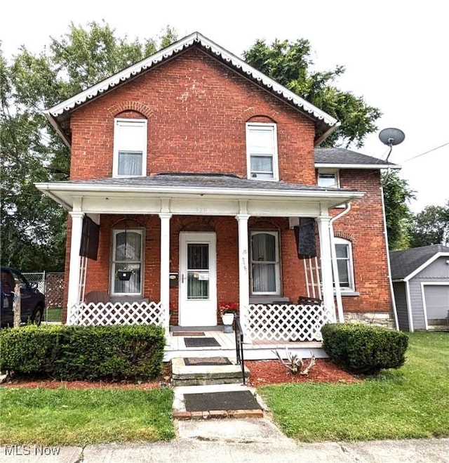 view of front of house featuring brick siding and a porch