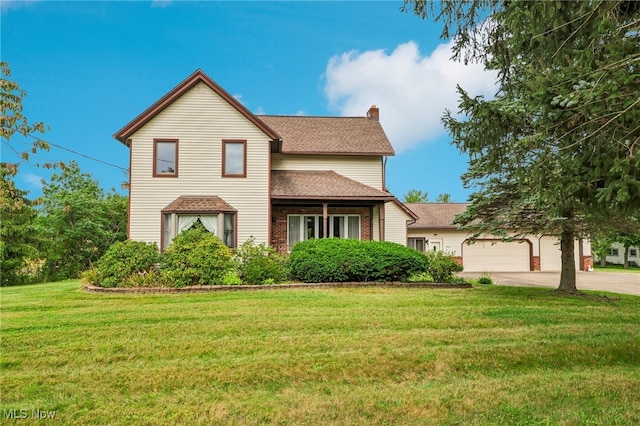 view of front property featuring a garage and a front yard