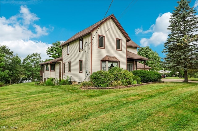 view of side of home featuring a lawn