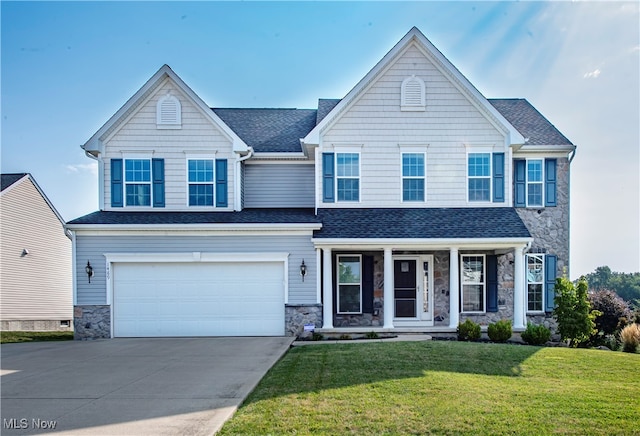 view of front of property featuring a garage and a front lawn