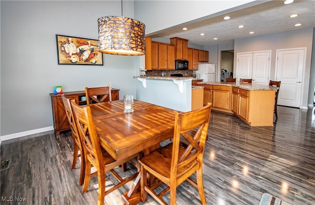 dining space featuring dark hardwood / wood-style floors