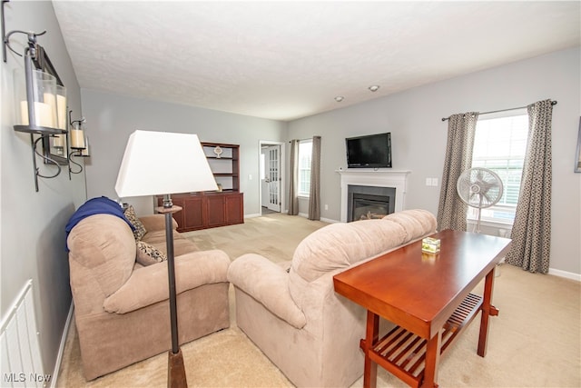 carpeted living room featuring a fireplace