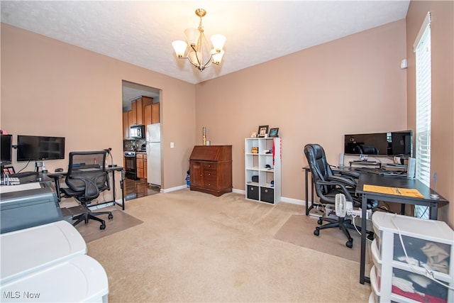 office space with a notable chandelier, a textured ceiling, and light carpet