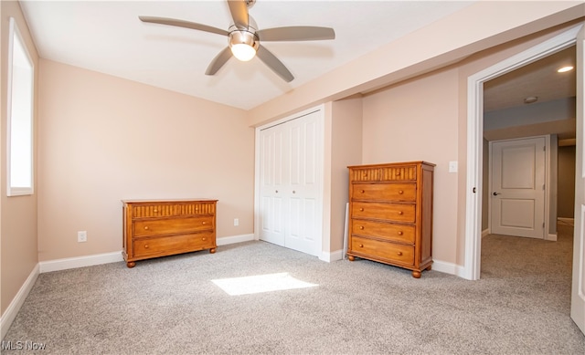 bedroom with ceiling fan, carpet flooring, and a closet