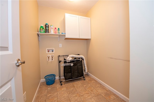 laundry room with light tile patterned floors, washer hookup, and cabinets