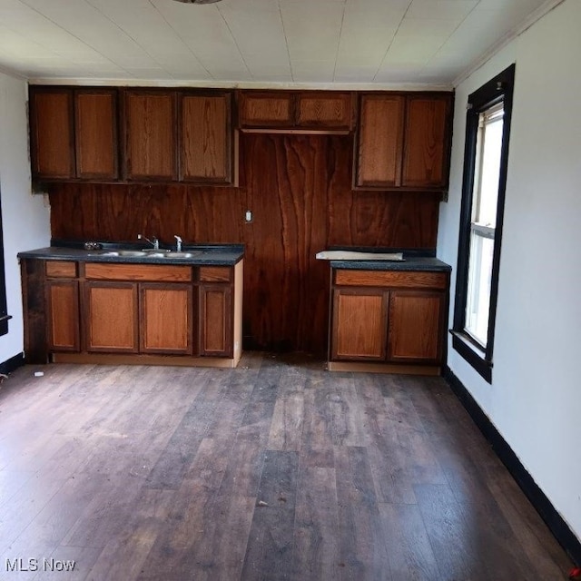 kitchen with dark wood-type flooring and ornamental molding