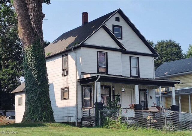 exterior space featuring a porch and a lawn