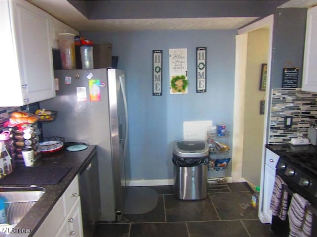 kitchen with wall oven, baseboards, white cabinets, decorative backsplash, and a sink