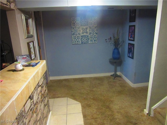 interior space featuring tile patterned floors and baseboards