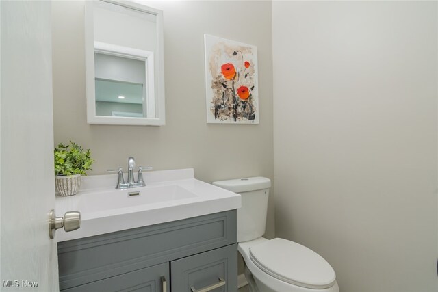 bathroom featuring toilet and vanity