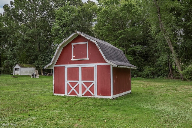 view of outdoor structure featuring a lawn