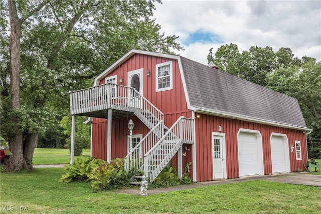 view of outdoor structure with a garage and a lawn