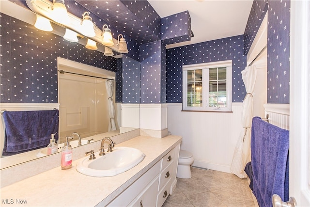 bathroom with tile patterned flooring, toilet, and vanity