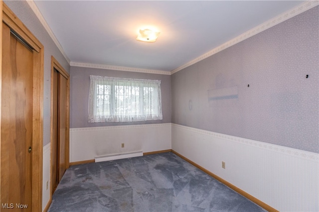 unfurnished bedroom with dark colored carpet, crown molding, and a baseboard radiator