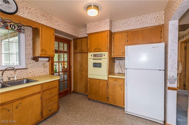 kitchen featuring sink and white appliances