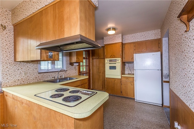 kitchen featuring sink, white appliances, island range hood, and kitchen peninsula