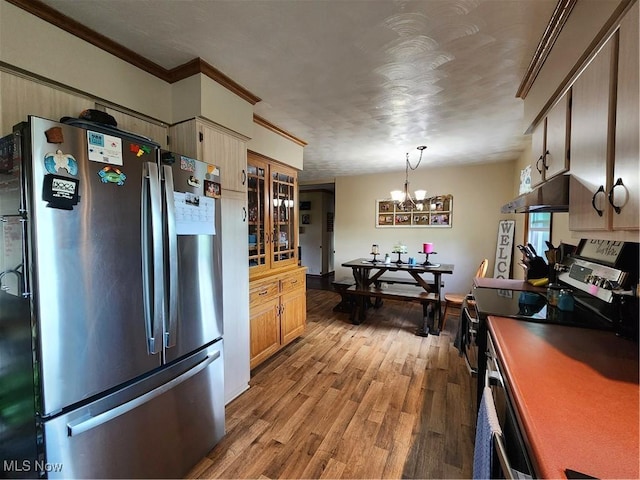 kitchen with wood-type flooring, hanging light fixtures, ornamental molding, a notable chandelier, and stainless steel appliances