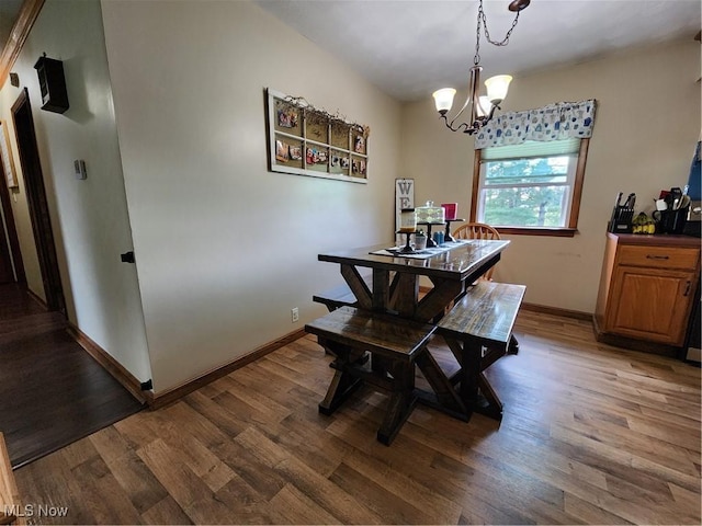 dining space featuring an inviting chandelier and dark hardwood / wood-style floors