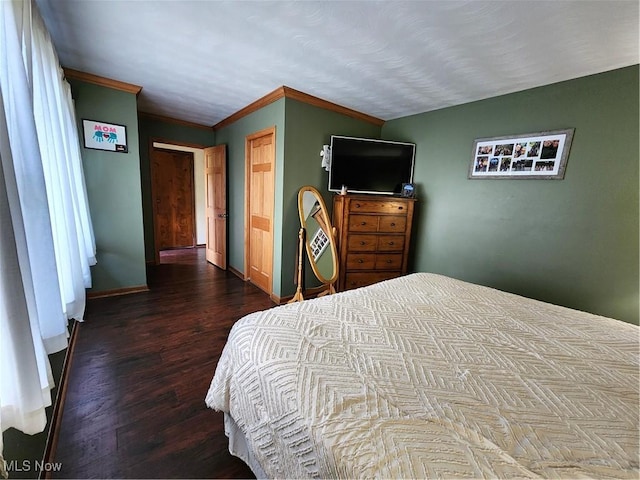 bedroom featuring dark wood-type flooring and ornamental molding