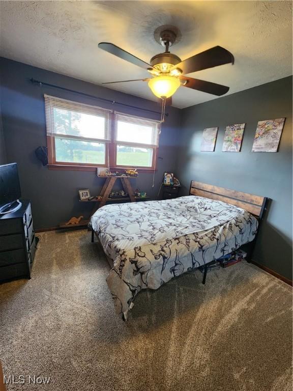 bedroom featuring ceiling fan and carpet flooring