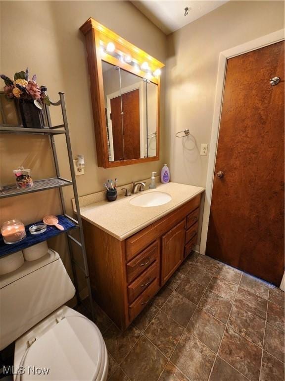 bathroom featuring vanity and toilet