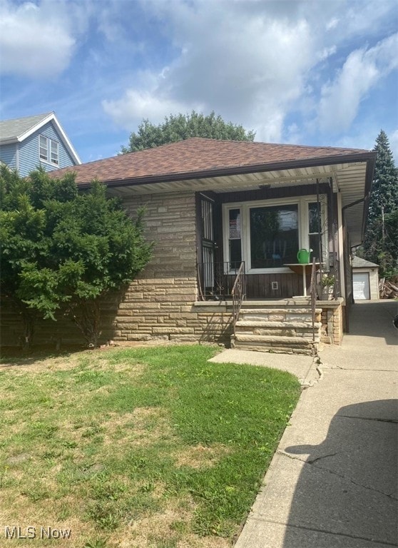 view of front facade with a garage, a front yard, and a porch