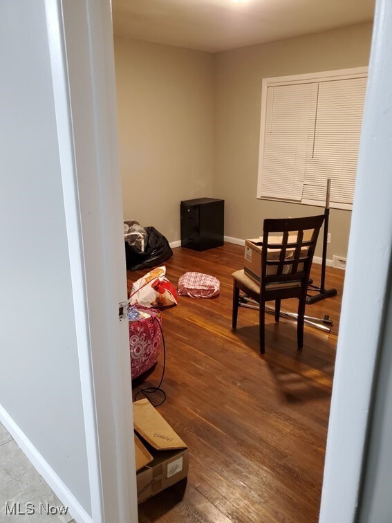 interior space featuring baseboards and wood finished floors