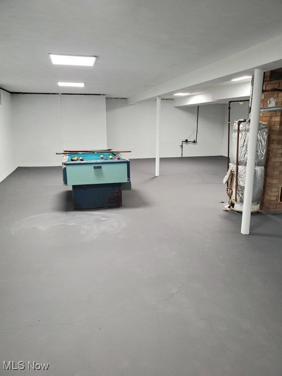 recreation room with pool table and concrete flooring