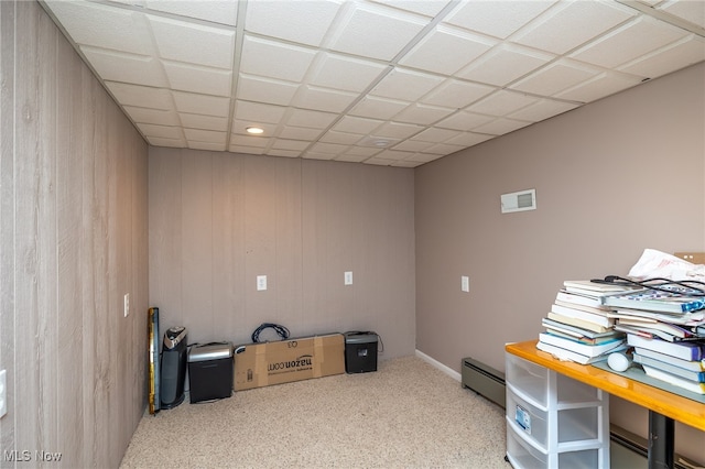 miscellaneous room featuring a paneled ceiling and a baseboard heating unit