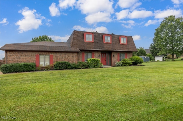 view of front of property with an outbuilding and a front lawn