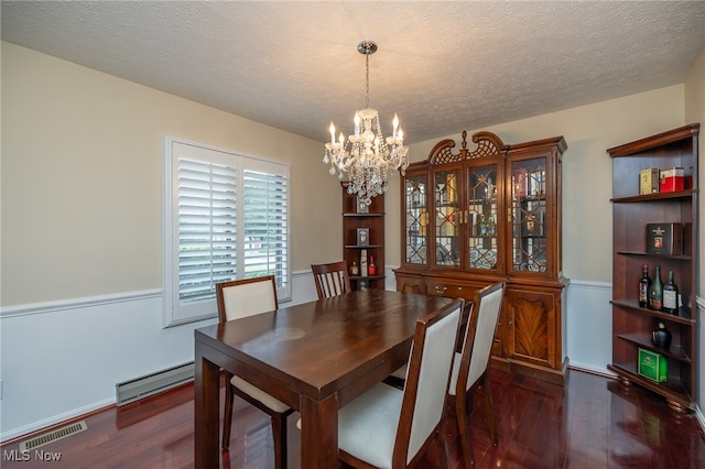 dining room with a textured ceiling, baseboard heating, a chandelier, and dark hardwood / wood-style flooring