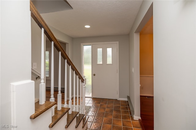 foyer with a textured ceiling