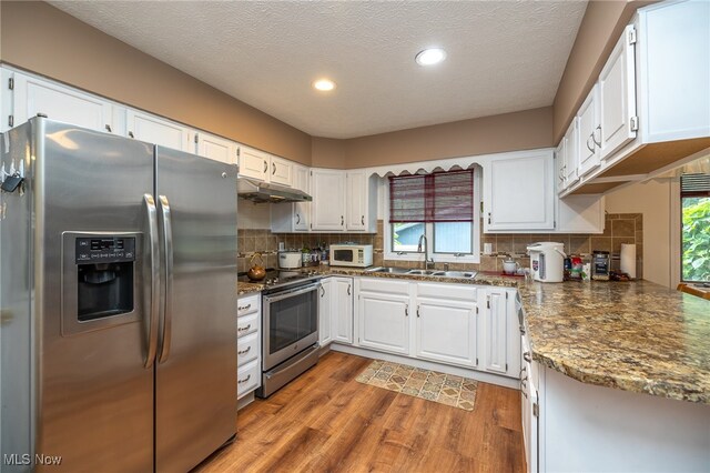 kitchen with sink, stainless steel appliances, and white cabinets